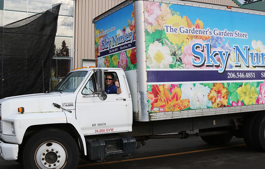 sky delivery truck with sky associate giving the thumbs up