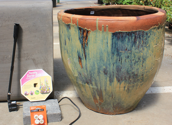 turn a beautiful ceramic pot into a water feature with a pump, a plug for the hole and plants