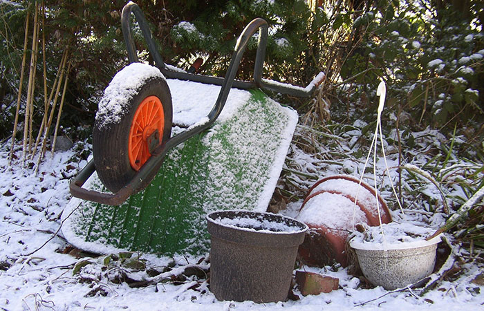 Wheelbarrow and pots in the snow